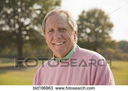 Stock Image - Man smiling outdoors. Fotosearch