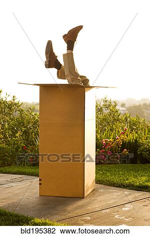 Man upside-down in cardboard box View Large Photo Image Stock Image - Man upside-down in cardboard box. Fotosearch