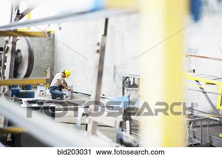 Man working in manufacturing plant View Large Photo Image Stock Image - Man working in manufacturing plant. Fotosearch