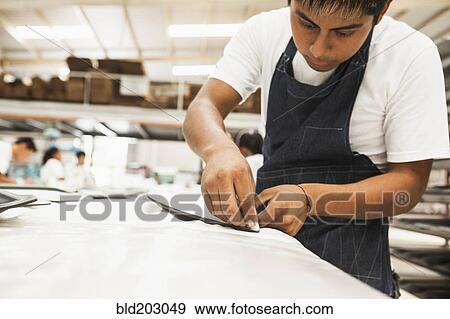 Man working in manufacturing plant View Large Photo Image Stock Photo - Man working in manufacturing plant. Fotosearch