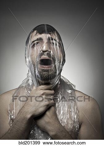 Stock Photo - Man wrapped in plastic. Fotosearch
