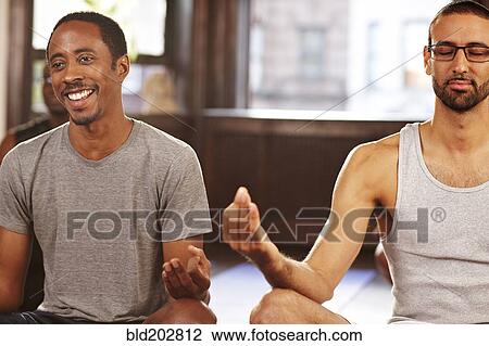 Men meditating in yoga class View Large Photo Image Stock Image - Men meditating in yoga class. Fotosearch