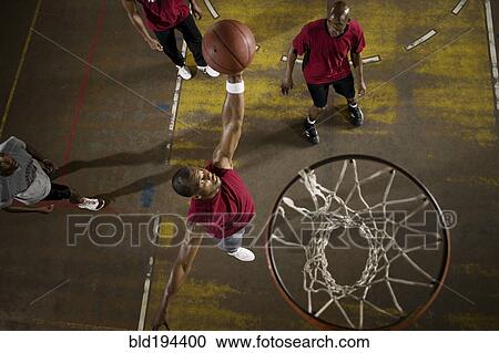 Stock Image - Men playing basketball. Fotosearch