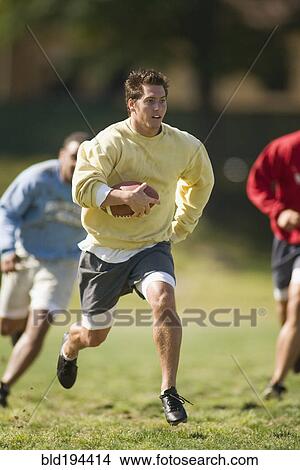 Picture - Men playing football. Fotosearch