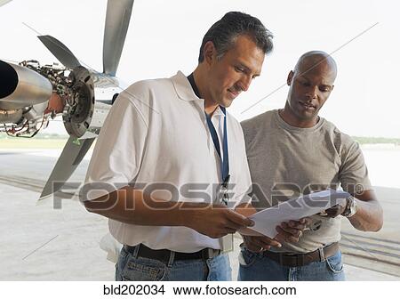 Men working in airplane hangar View Large Photo Image Picture - Men working in airplane hangar. Fotosearch