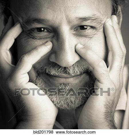 Stock Photo - Middle Eastern man with head in hands. Fotosearch