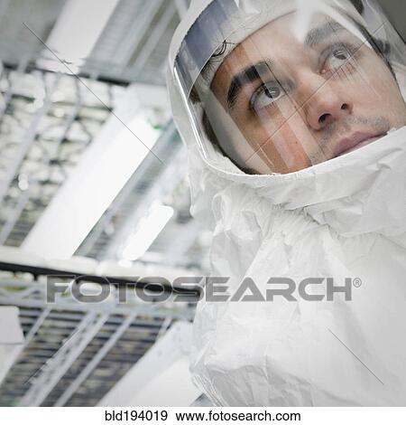 Stock Photo - Middle Eastern scientist in clean suit in laboratory. Fotosearch