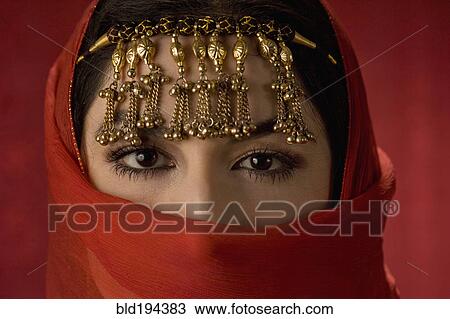 Stock Image - Middle Eastern woman in ornate headdress. Fotosearch