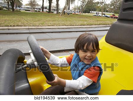 Stock Photo - Mixed race boy driving go-cart. Fotosearch