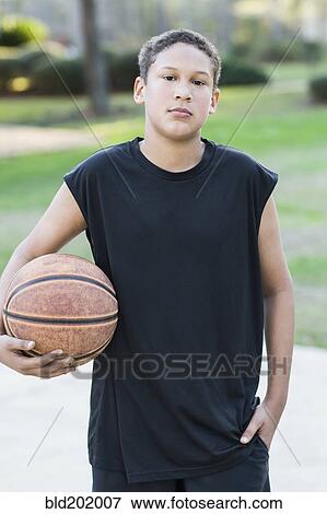 Mixed race boy holding basketball View Large Photo Image Stock Photo - Mixed race boy holding basketball. Fotosearch
