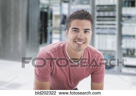 Stock Image - Mixed race businessman in server room. Fotosearch