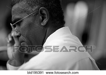 Mixed race businessman looking down View Large Photo Image Stock Image - Mixed race businessman looking down. Fotosearch