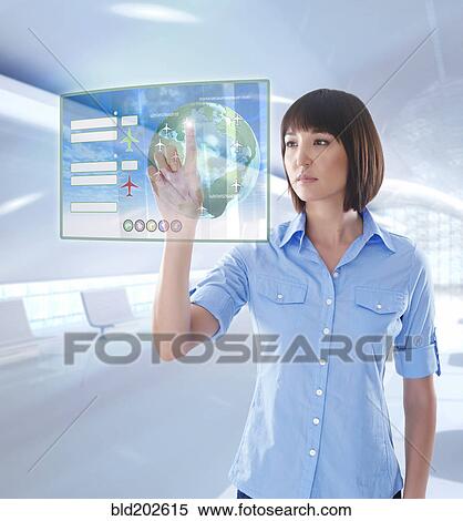 Stock Photography - Mixed race businesswoman using digital display. Fotosearch
