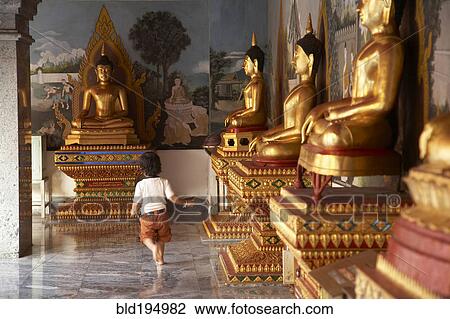 Mixed race child running past Buddha statues View Large Photo Image Stock Image - Mixed race child running past Buddha statues. Fotosearch