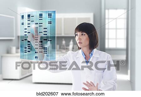 Stock Photo - Mixed race doctor using digital display in a lab. Fotosearch
