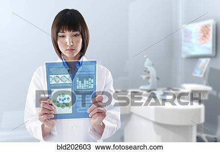 Mixed race doctor using digital tablet in laboratory View Large Photo Image Stock Image - Mixed race doctor using digital tablet in laboratory. Fotosearch