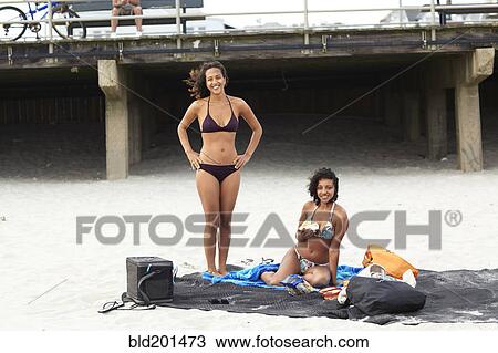 Mixed race friends enjoying beach View Large Photo Image Stock Image - Mixed race friends enjoying beach. Fotosearch