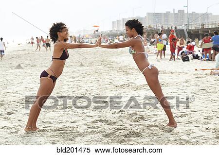 Mixed race friends playing on beach View Large Photo Image Stock Photography - Mixed race friends playing on beach. Fotosearch