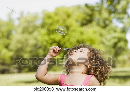 Mixed race girl blowing bubbles View Large Photo Image Stock Image - Mixed race girl blowing bubbles. Fotosearch