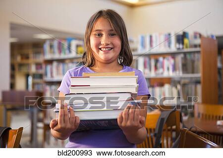 Mixed race girl carrying library books View Large Photo Image Stock Image - Mixed race girl carrying library books. Fotosearch