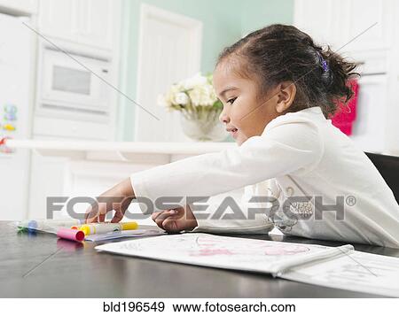 Stock Photo - Mixed race girl drawing in notebook. Fotosearch