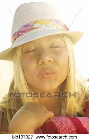 Stock Photo - Mixed race girl making kissing motion. Fotosearch