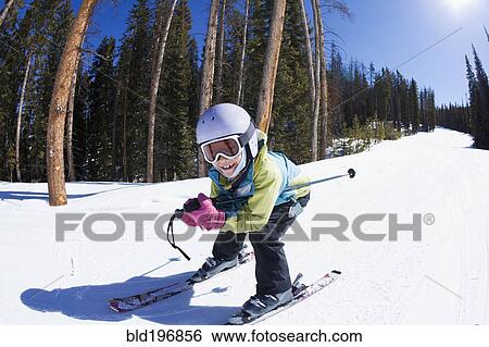 Stock Photograph - Mixed race girl skiing downhill. Fotosearch