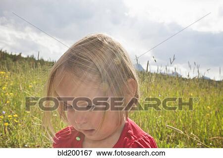 Stock Photo - Mixed race girl standing in field. Fotosearch
