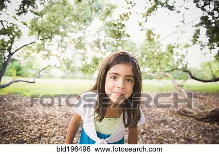 Mixed race girl standing outdoors View Large Photo Image Stock Photograph - Mixed race girl standing outdoors. Fotosearch