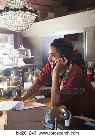 Mixed race man working in coffee shop View Large Photo Image Stock Image - Mixed race man working in coffee shop. Fotosearch