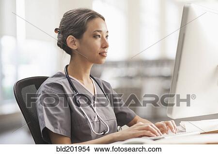 Mixed race nurse using computer View Large Photo Image Picture - Mixed race nurse using computer. Fotosearch