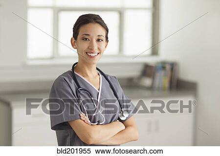 Mixed race nurse with arms crossed View Large Photo Image Stock Photography - Mixed race nurse with arms crossed. Fotosearch