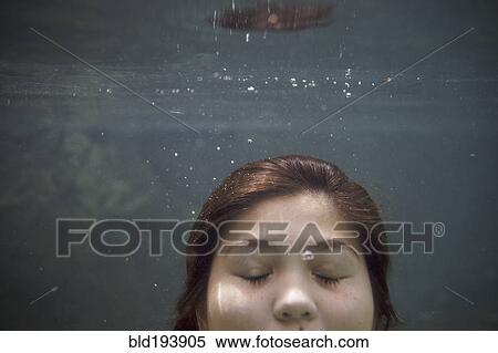 Stock Photography - Mixed race teenager underwater. Fotosearch