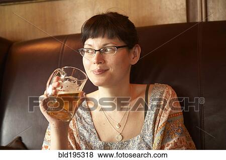 Mixed race woman drinking beer View Large Photo Image Stock Photo - Mixed race woman drinking beer. Fotosearch