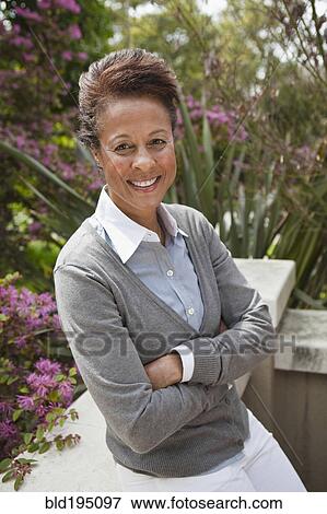 Mixed race woman enjoying garden View Large Photo Image Stock Photo - Mixed race woman enjoying garden. Fotosearch