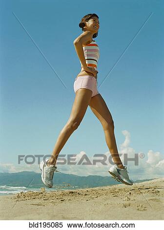 Mixed race woman exercising on beach View Large Photo Image Stock Photography - Mixed race woman exercising on beach. Fotosearch