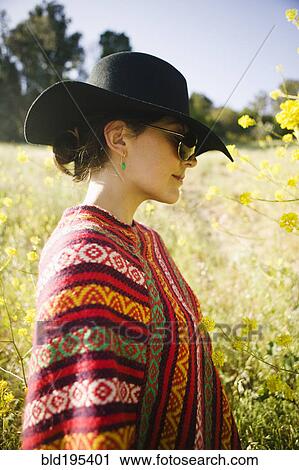 Stock Image - Mixed race woman in field. Fotosearch