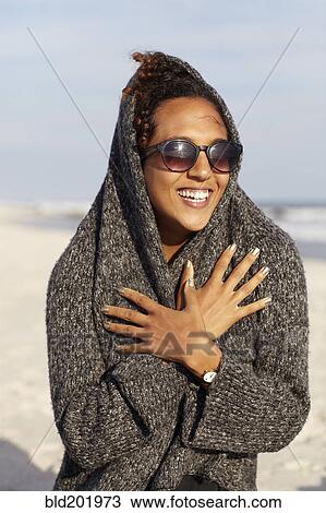 Mixed race woman in sweater on beach View Large Photo Image Stock Image - Mixed race woman in sweater on beach. Fotosearch