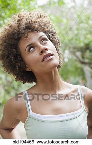 Stock Photograph - Mixed race woman looking up. Fotosearch
