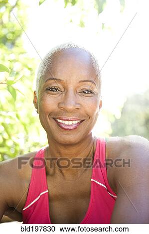 Stock Image - Mixed race woman smiling outdoors. Fotosearch