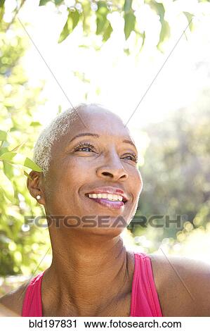 Mixed race woman smiling outdoors View Large Photo Image Stock Image - Mixed race woman smiling outdoors. Fotosearch