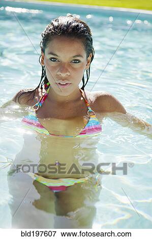 Mixed race woman swimming in swimming pool View Large Photo Image Stock Photo - Mixed race woman swimming in swimming pool. Fotosearch