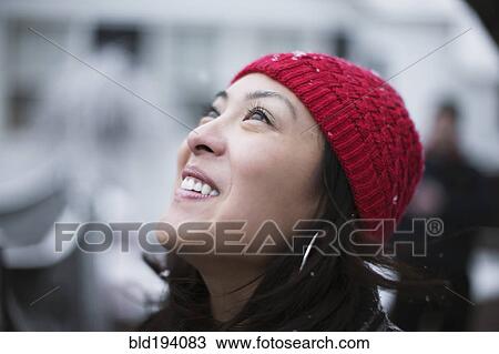 Mixed race woman watching it snow View Large Photo Image Stock Image - Mixed race woman watching it snow. Fotosearch