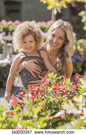 Stock Photo - Mother and daughter at plant nursery. Fotosearch