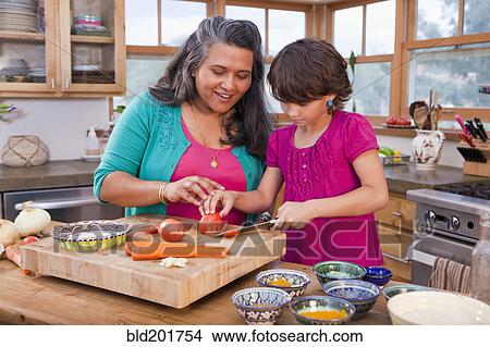 Picture - Mother and daughter cooking in kitchen. Fotosearch