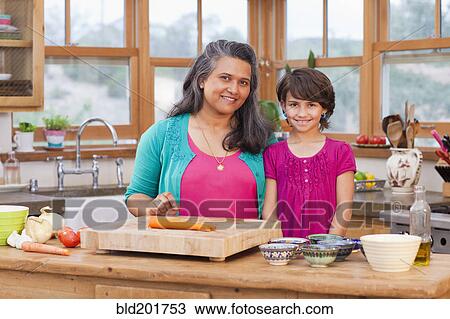 Mother and daughter cooking in kitchen View Large Photo Image Stock Image - Mother and daughter cooking in kitchen. Fotosearch