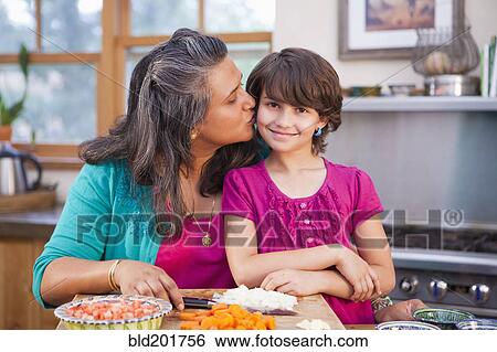 Mother and daughter cooking in kitchen View Large Photo Image Stock Photograph - Mother and daughter cooking in kitchen. Fotosearch