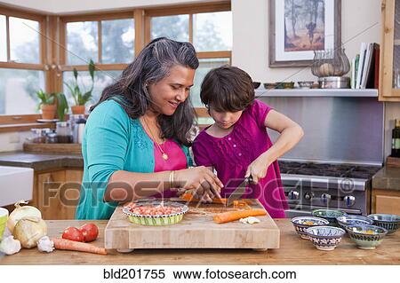 Mother and daughter cooking in kitchen View Large Photo Image Stock Photography - Mother and daughter cooking in kitchen. Fotosearch