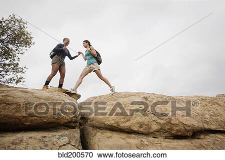Stock Image - Mother and daughter hiking together. Fotosearch