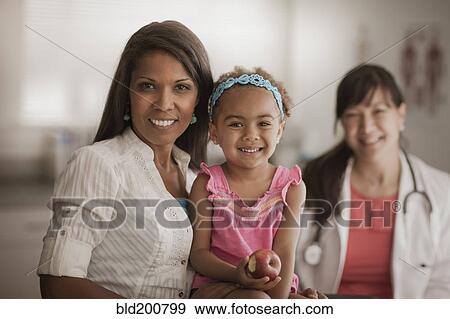 Mother and daughter in doctor's office View Large Photo Image Stock Photo - Mother and daughter in doctor's office. Fotosearch